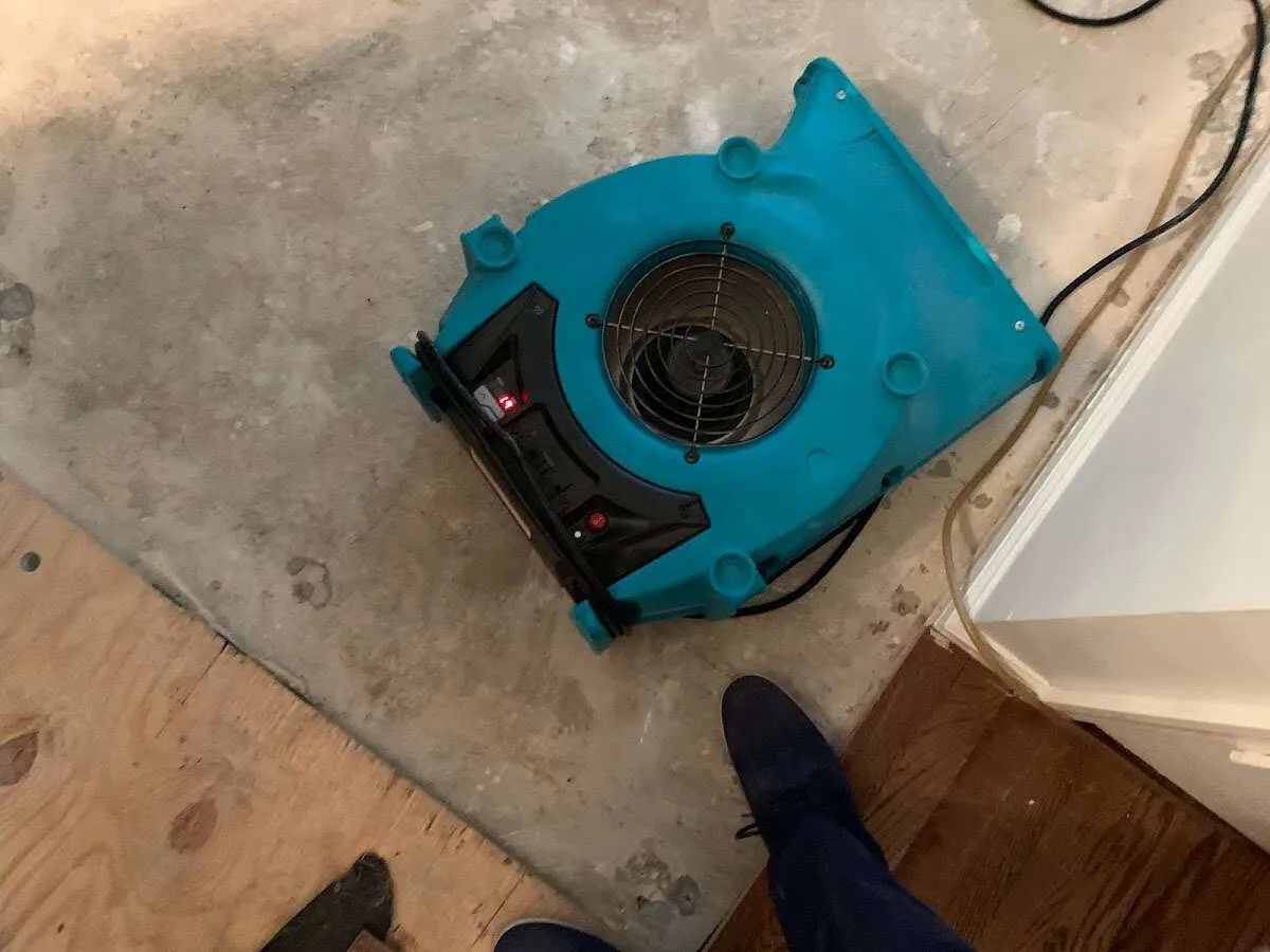 Air mover drying subfloor during Commercial Water Damage Restoration in Newburyport